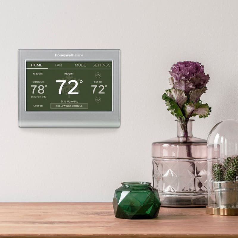 Honeywell Home Smart Color Thermostat with a table and misc knicknacks