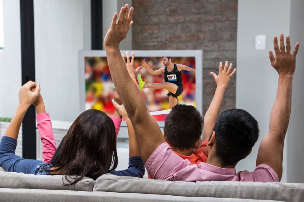 Family watching sports on TV