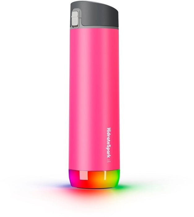 HidrateSpark PRO Smart Water Bottle in bright pink with the lights glowing to show you need to drink.
