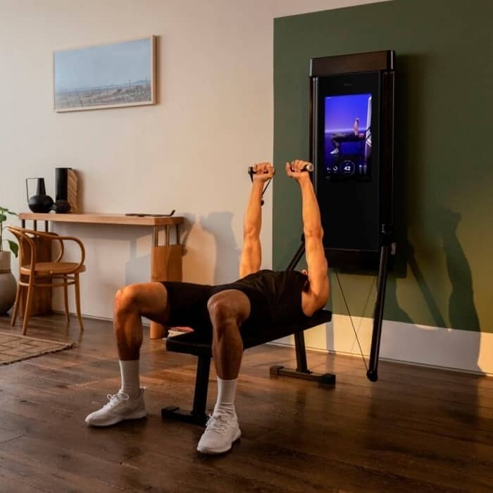 Man using a Tonal workout system in a natural toned room.
