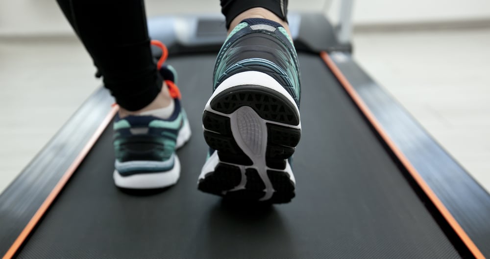 Shot of a woman's shoes on a treadmill.