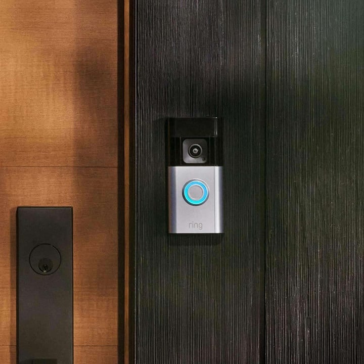 Ring Battery Doorbell Pro on a wood doorframe.