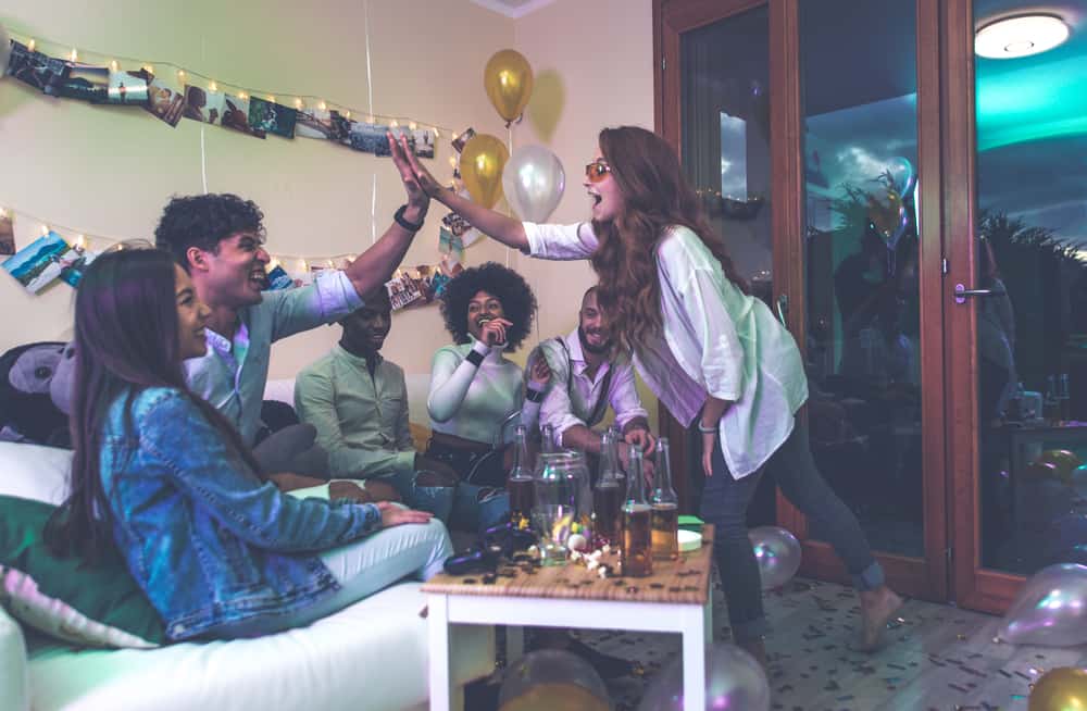 A group of young people celebrating at a house party