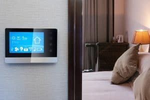 Smart home display with bedroom in background.
