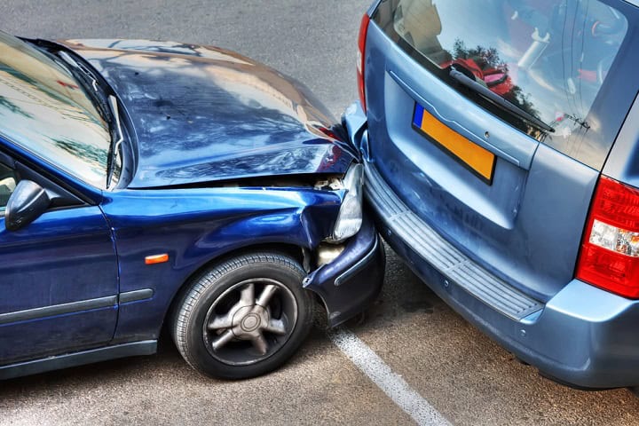Blue van being rear ended by a blue car.