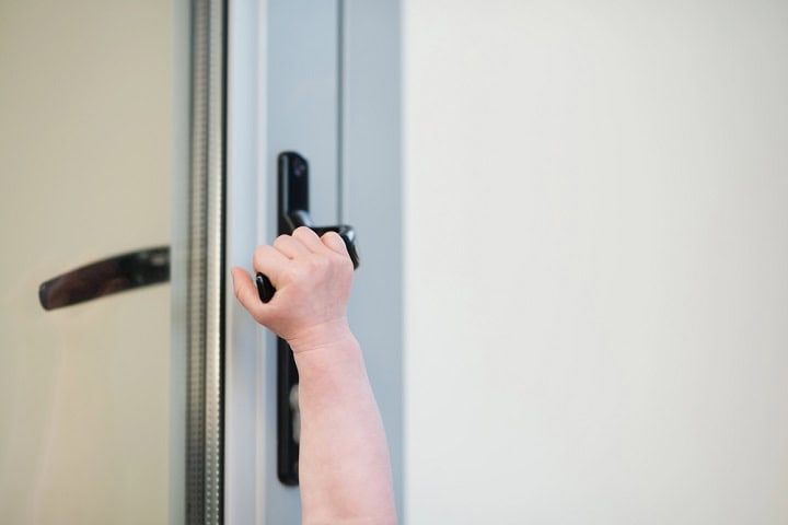 Young child's arm opening a arcadia door.