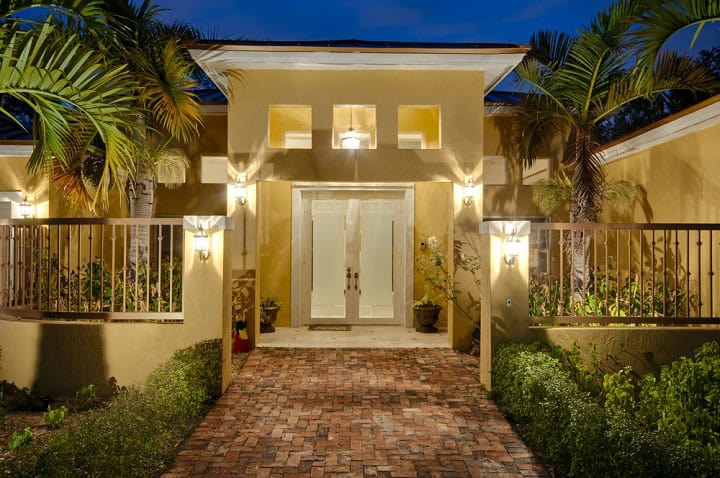 Front entryway of house at dusk with lights turned on.