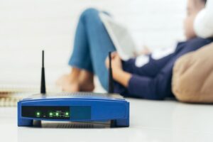 Wireless router and kids using a Tablet in home.