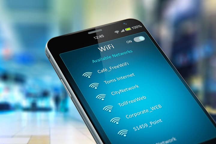 Cell phone displaying nearby wireless networks and their names.