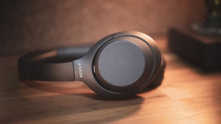 Sony noise cancelling headphones on a wooden table.