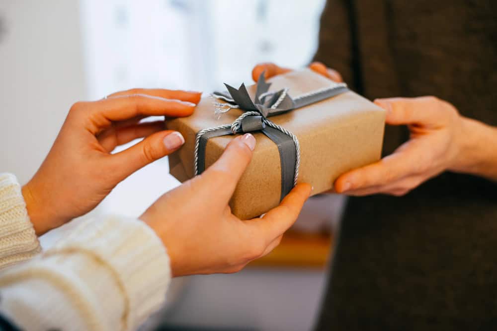 Two people exchanging a gift.