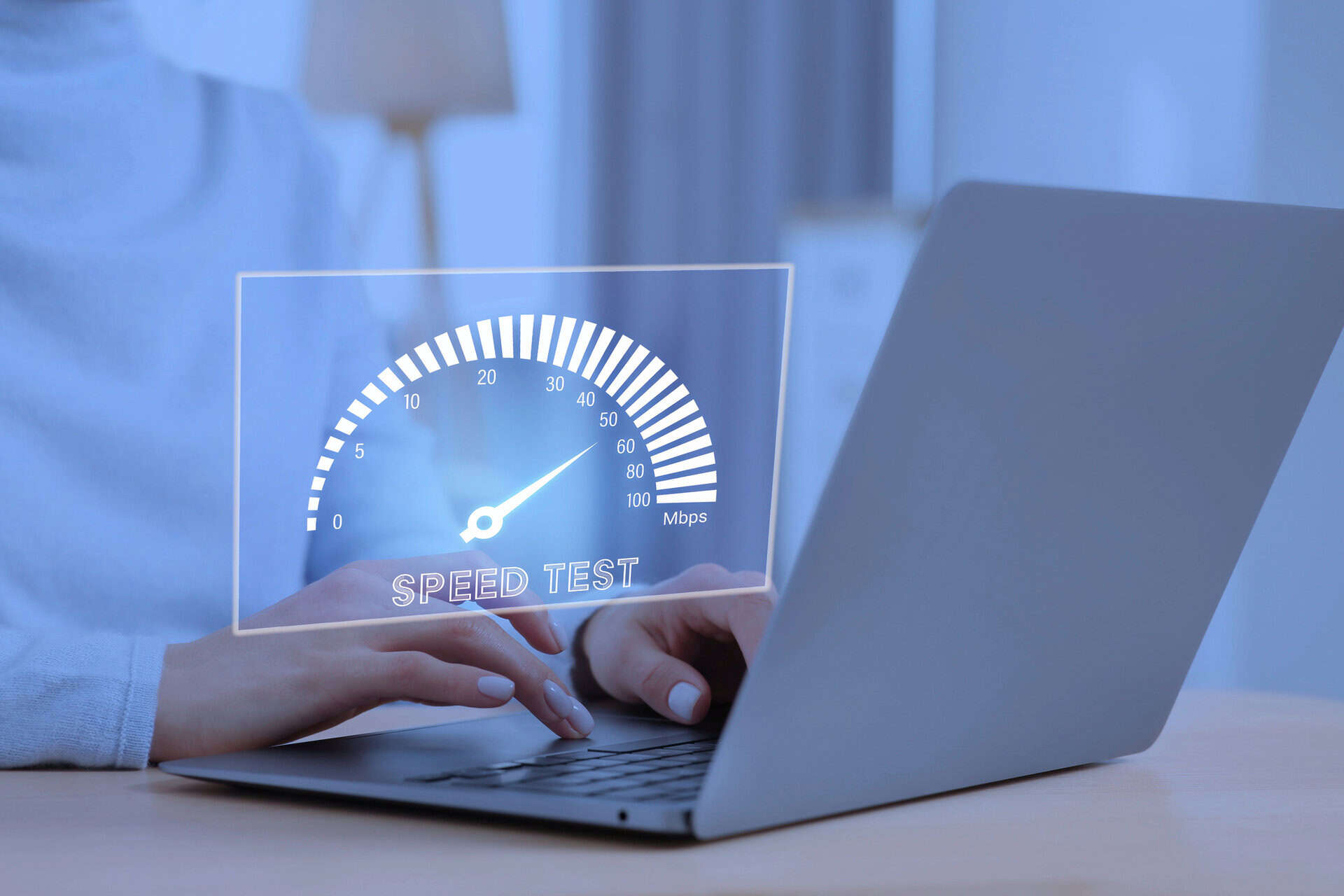 Person sitting at a laptop, overlaid with an image for a speed test.