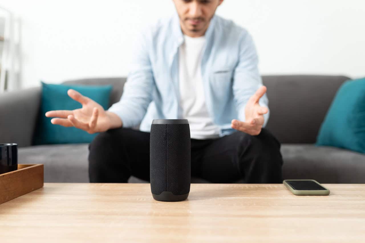 Confused man feeling angry because his new smart speaker is not working properly
