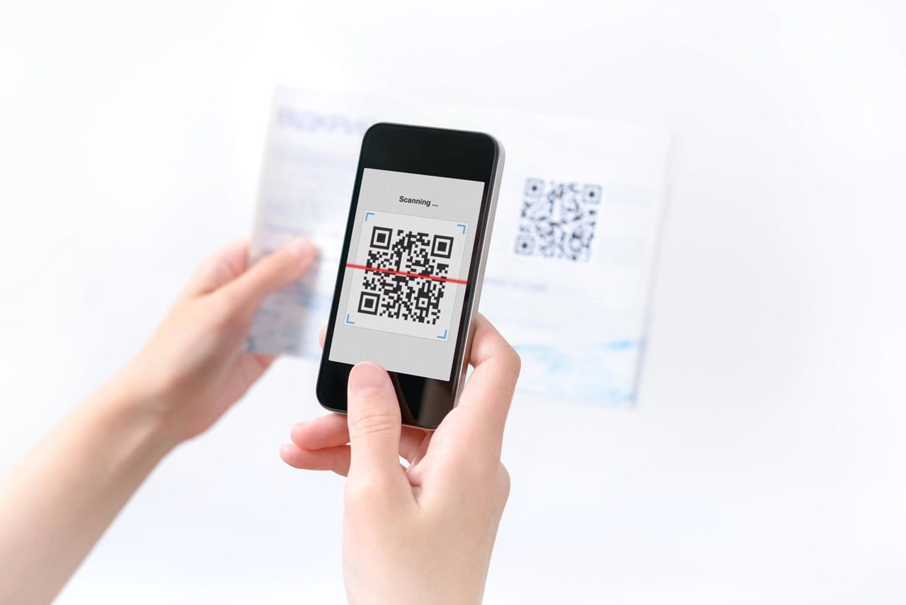 Woman scanning QR code in the magazine on mobile smart phone.