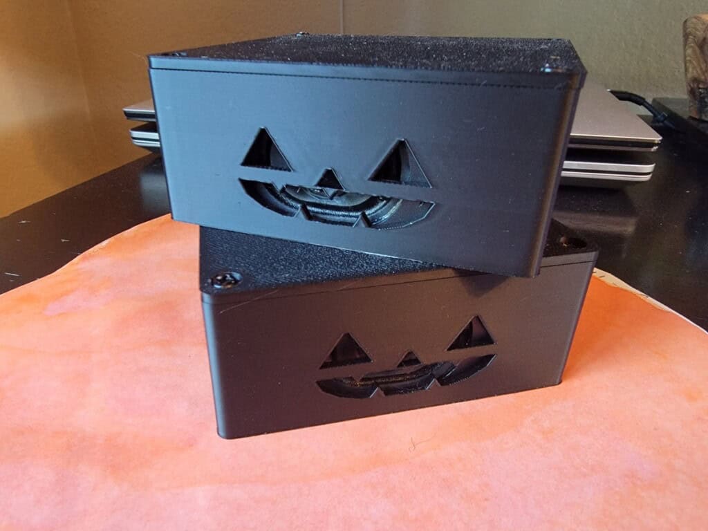 Halloween Speakers with Jack-o-lantern faces stacked on a desk
