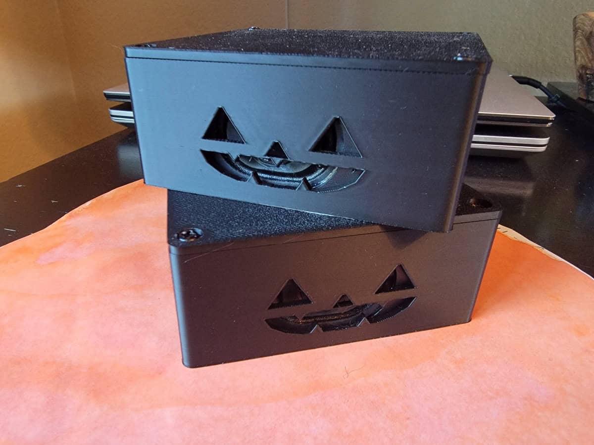 Halloween Speakers with Jack-o-lantern faces stacked on a desk